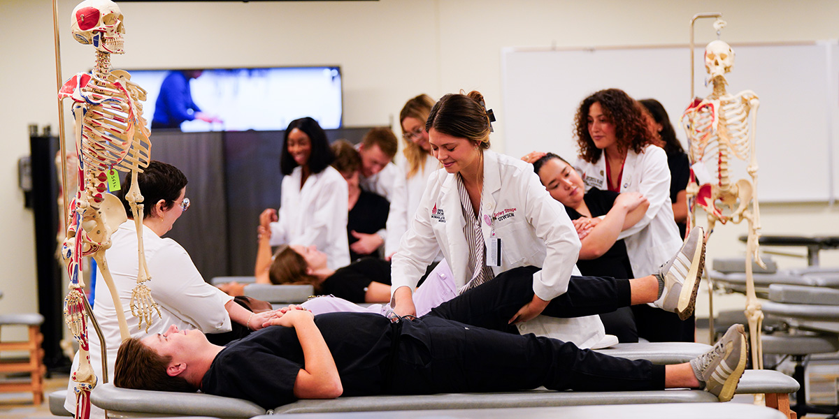 Student walking into the School of Osteopathic Medicine