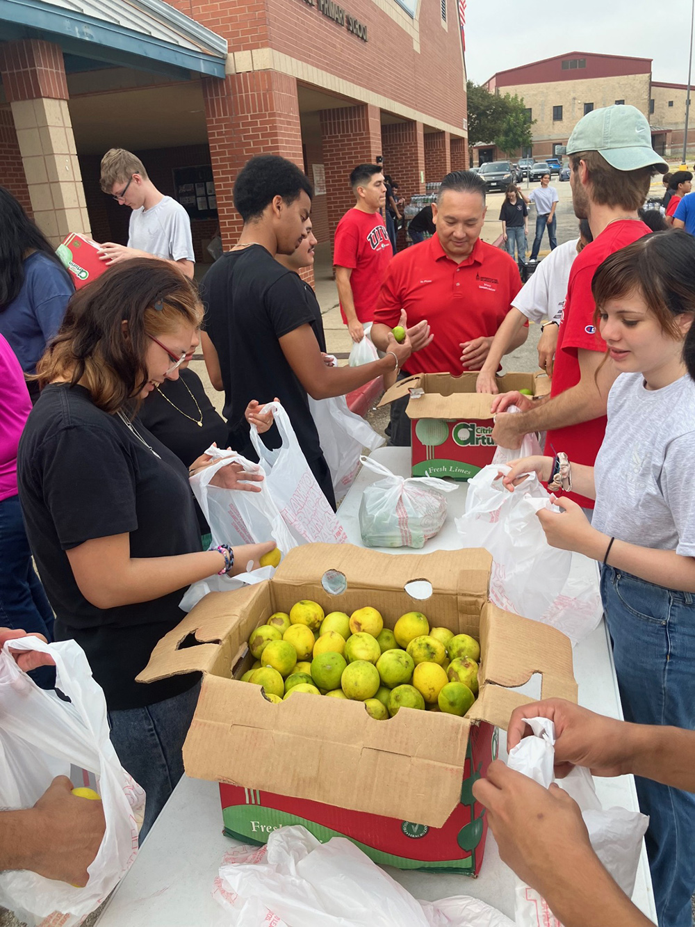 Students volunteer with Dean Pham at Southside ISD Food Bank event