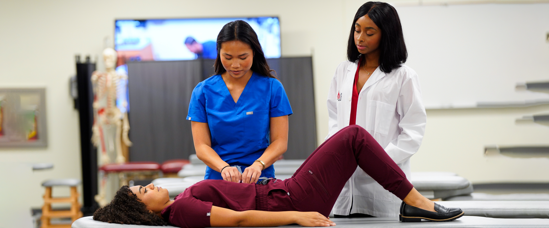 Two students tending to a patient